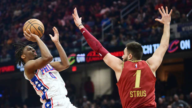 Feb 12, 2024; Cleveland, Ohio, USA; Philadelphia 76ers guard Tyrese Maxey (0) shoots over the defense of Cleveland Cavaliers guard Max Strus (1) during the first half at Rocket Mortgage FieldHouse. Mandatory Credit: Ken Blaze-USA TODAY Sports